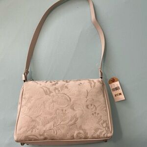 Cream or ivory purse with beautiful embroidery on front.